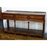 An 18th century oak Dresser Base, moulded top above three geometrically fronted frieze drawers,