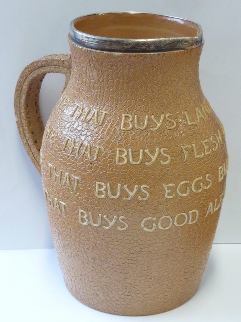 A late 19th century Doulton Lambeth/Slater's Patent stoneware motto Jug with silver rim "He that