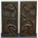 A pair of 17th century carved oak Romayne Panels, carved with figures in profile,