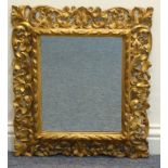 A 19th century pierced and carved giltwood Florentine style wall hanging Looking Glass the frame