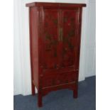 An early 20th century Chinese red lacquer two-door Cabinet,