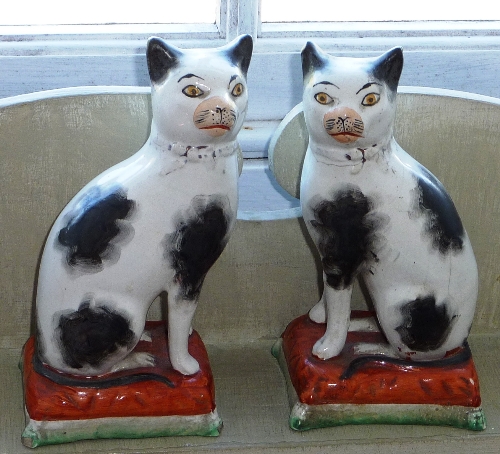 A pair of 19th century Staffordshire Cats (damage and reparations),