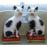 A pair of 19th century Staffordshire Cats (damage and reparations),