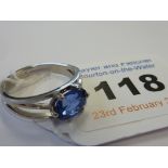 A hallmarked platinum single-sapphire Ring set with an oval cornflower-blue sapphire which measures
