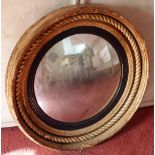 An early 19th century gilt framed wall hanging convex-shaped Looking Glass having a rope style