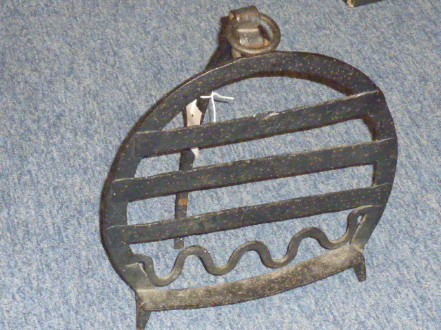 A large early 19th century wrought iron Fire Trivet of horseshoe design,