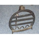 A large early 19th century wrought iron Fire Trivet of horseshoe design,