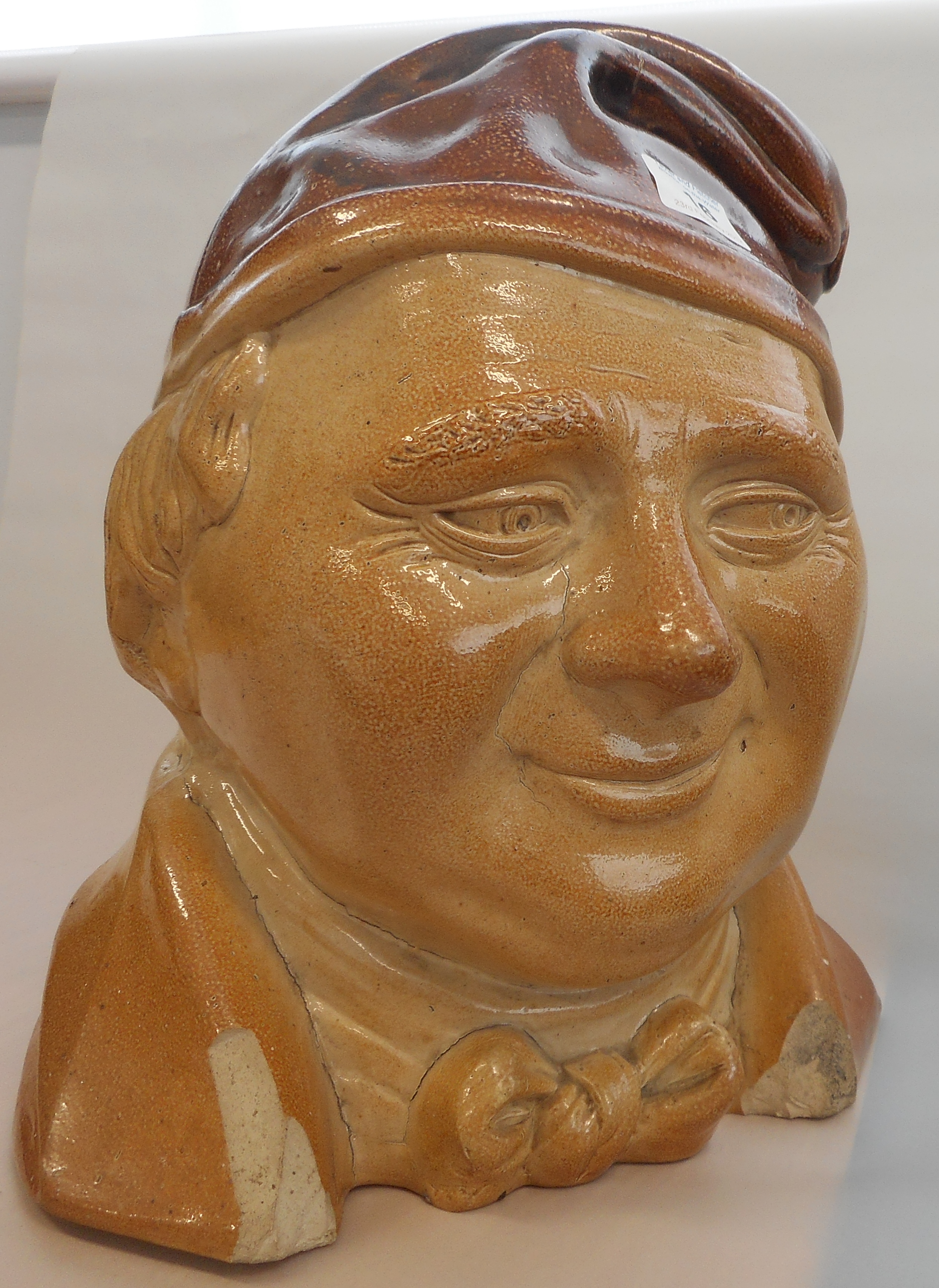 A large 19th century salt glaze stoneware Flask modelled as a Dickensian type character,