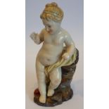 A 19th century porcelain Figurine of a Putto on a rocky base looking at a red heart at her feet,