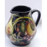 A late 20th century Moorcroft pottery Jug of baluster form, tube-lined and decorated with peaches,