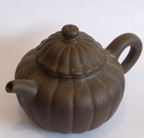 A Chinese melon form Yixing Teapot, four-character mark to underside of base,