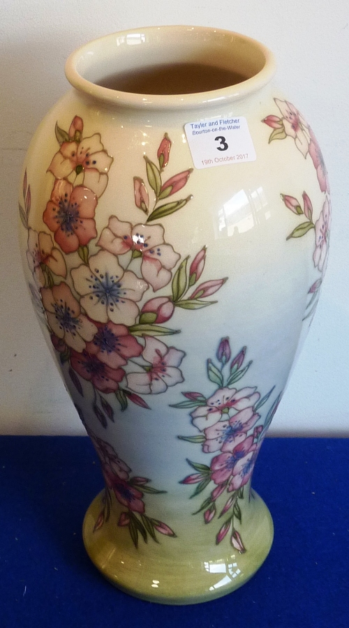 A large Moorcroft Vase with pale cream background and trailing flowers,