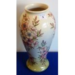 A large Moorcroft Vase with pale cream background and trailing flowers,