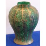A large baluster shaped green painted and vertically gilt drizzled pottery Vase of modern
