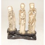 A group of three early 20th Century Japanese carved ivory figures of deities, each carved separately