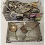 A quantity of silver plated cutlery, decanter label, cruet base, tea strainer and similar items (a