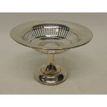 An Edwardian silver pedestal bon bon dish by Asprey, London, with pierced decoration and on stepped,