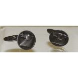 A pair of "GEORG JENSEN" silver cufflinks, the circular panels with stylized horse head motif,