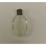 A small faceted clear glass scent bottle with hinged silver metal cover, 6.25cms