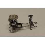 A small Chinese silver figure of a man pulling a rickshaw, with character marks, 8cms wide