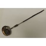 A Georgian silver toddy ladle the oval bowl with inset George III sixpence and with twisted horn