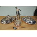 A silver plated jug with leather bound handle; decorative silver plated spoon; two entree dishes and