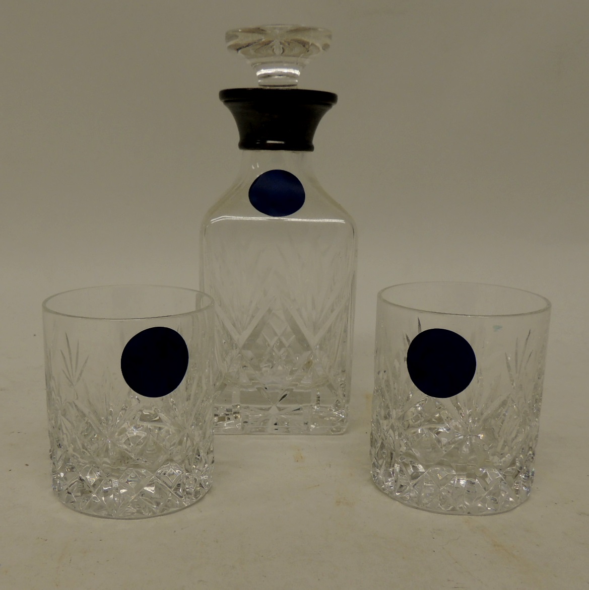 A silver mounted cut glass spirit decanter with stopper and together with two matching small