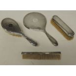 A George V silver dressing table set with guilloche decoration comprising hair brush, clothes brush,