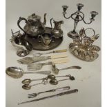 A silver plated egg cruet for four egg cups and four spoons; a silver plated circular tray and other