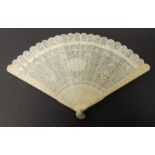 A late 19th Century Chinese carved ivory brise fan the guards worked with flowers and pagodas, the