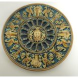 A late 19th Century Gebruder Schutz majolica wall plate with classical decoration, kneeling archer