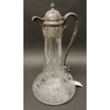 A Victorian silver mounted claret jug, the silver top with domed hinged cover having palmette