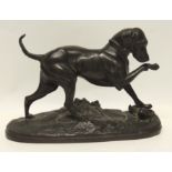 A late 19th Century hollow cast bronzed spelter figure of a dog with one front foot on a rabbit,