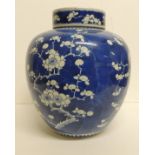 A large Chinese blue and white ginger jar and cover painted with prunus decoration and with blue