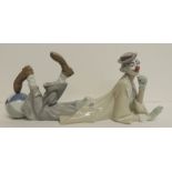 A large Lladro figure of a clown lying on his stomach with a beach ball under one foot, 37cms