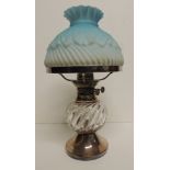 A good quality late Victorian/Edwardian table oil lamp with foliate moulded blue glass shade, silver