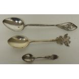 A Russian silver teaspoon with double headed eagle finial together with two other decorative