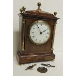 An Edwardian mantel timepiece in brass and mahogany architectural case having circular white