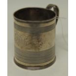 A George III silver Christening mug with banded decoration and engraved with scrolling initials,