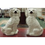 A pair of large Staffordshire pottery spaniels, 37cm high.