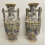 A large pair of 20th Century Japanese satsuma vases, each with square section handles and painted