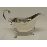 A Georgian style silver sauce boat with foliate capped flying scroll handle approx 7.5oz