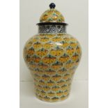 A large decorative 20th Century baluster vase and cover, faience style, painted with "scales" in