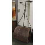 A vintage metal garden roller with open scroll work sides, roller 56cm wide.