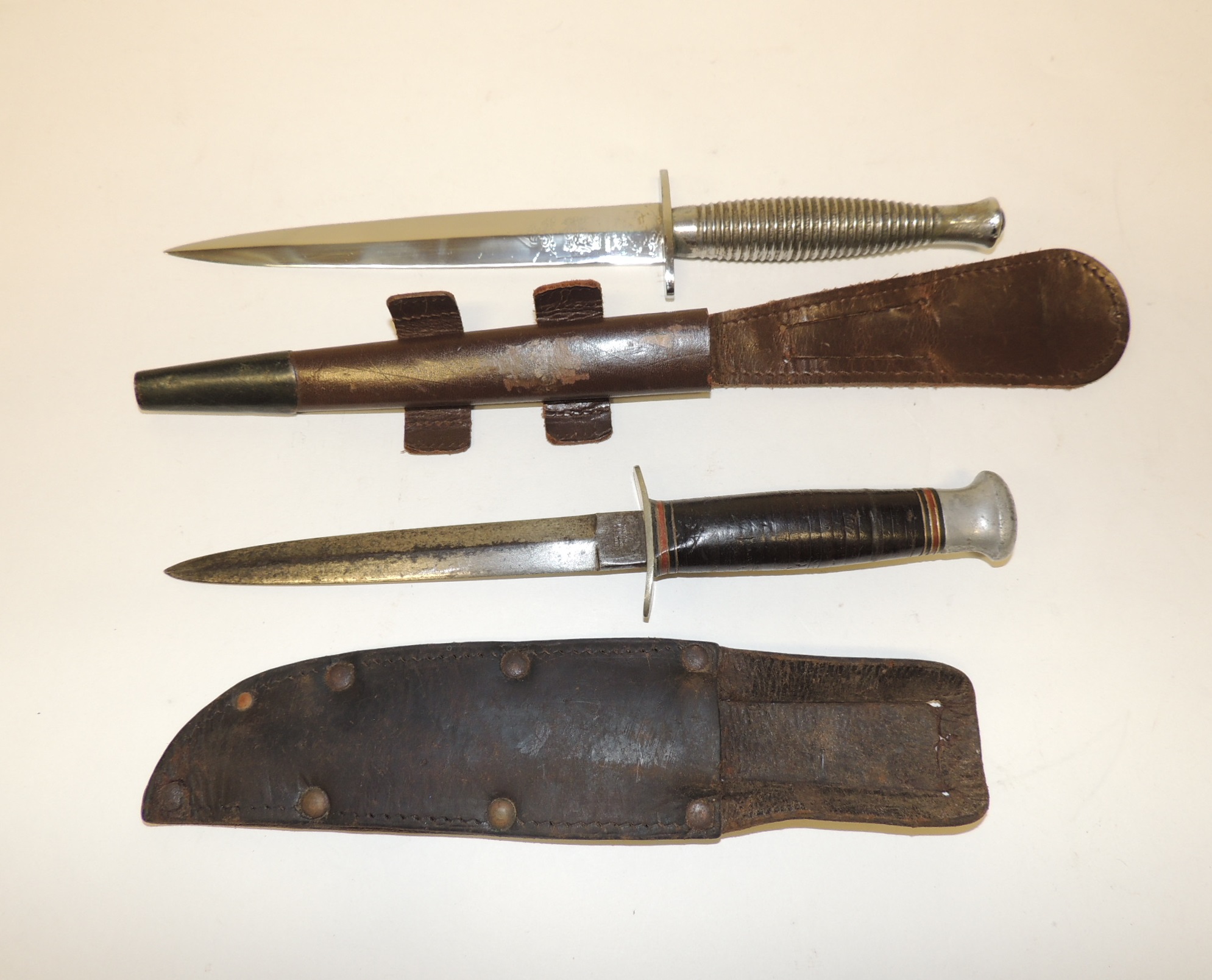 A WWII period dagger by William Rodgers, Sheffield having white metal pommel and leather grip,