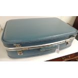 A set of three vintage graduated blue plastic suitcases, each fitting into the other, the smallest