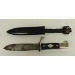 A German made Scout dagger having black chequered grip inset with Scout fleur de lis emblem, the