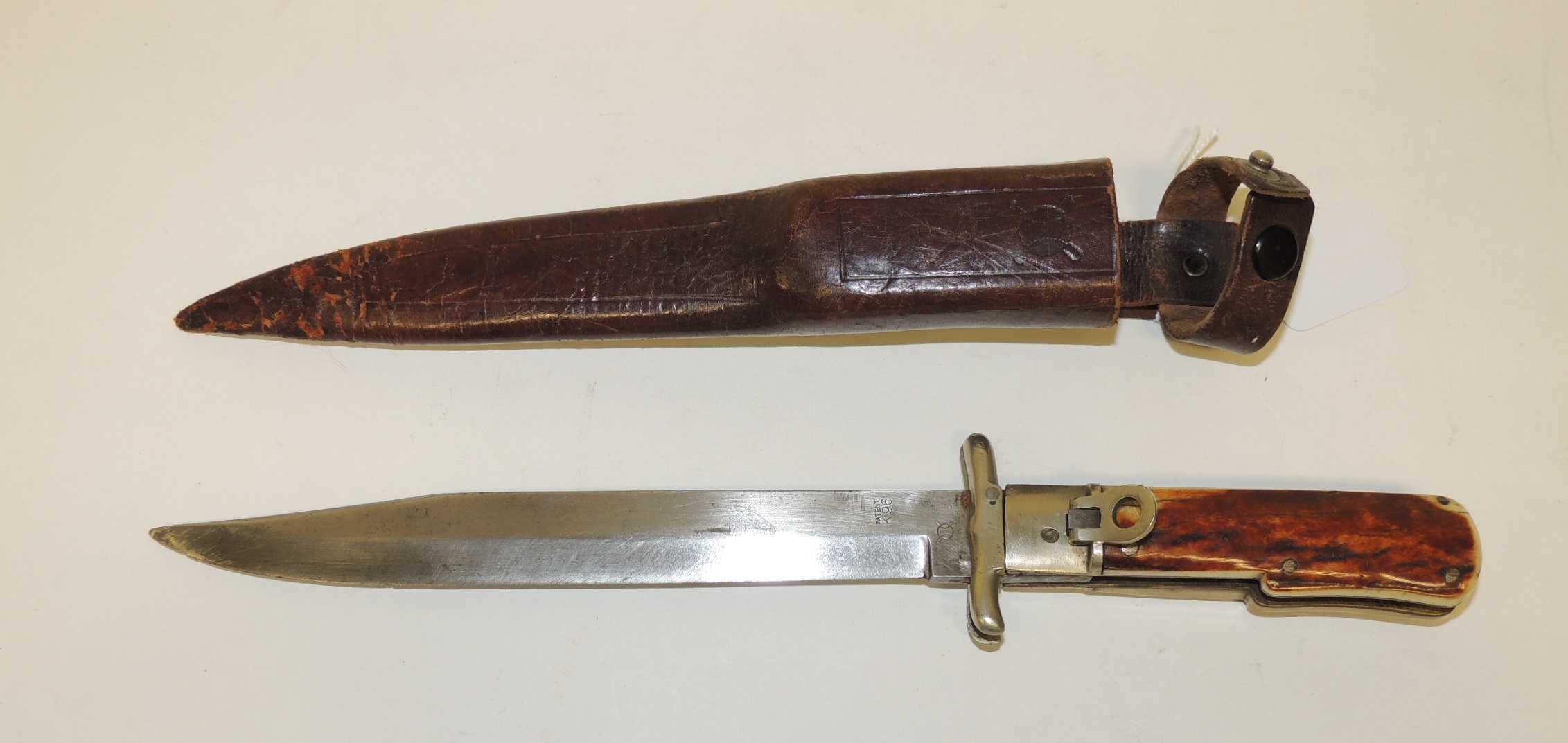 An early 20th Century hunting knife with long single edged folding blade marked "RSC Works" and "