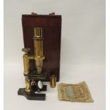 A brass monocular microscope by Baker, 244 High Holborn, London, the horseshoe base engraved with