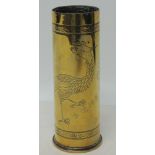 A brass shell 6pr case with decorative engraved Oriental inspired decoration of a Ho-o bird and